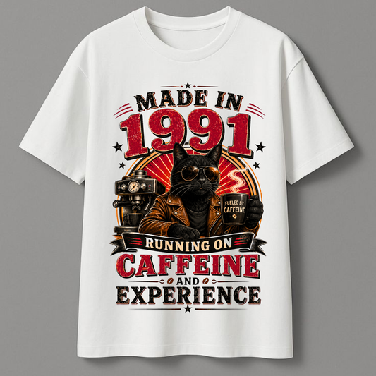 White t-shirt with a graphic of a cat wearing sunglasses and a leather jacket, text 'Made in 1991, Running on Caffeine and Experience' on a gray background.